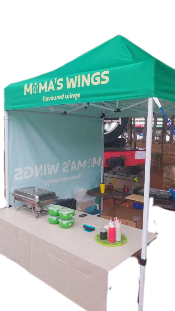 Mama's Wings branded catering gazebo serving fresh crispy chicken wings at an event